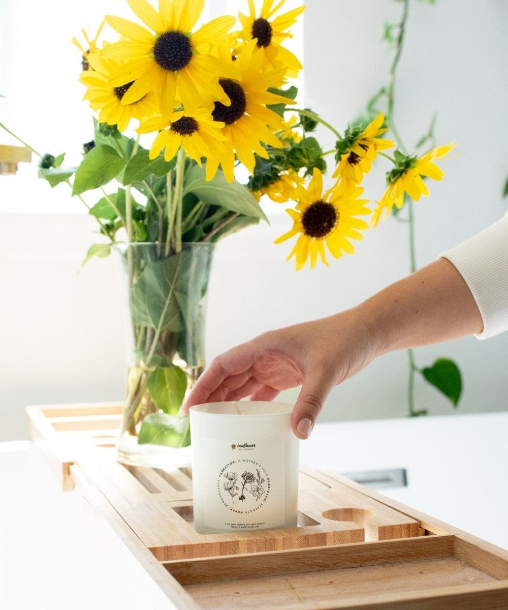 Person placing a small white container on a wooden tray