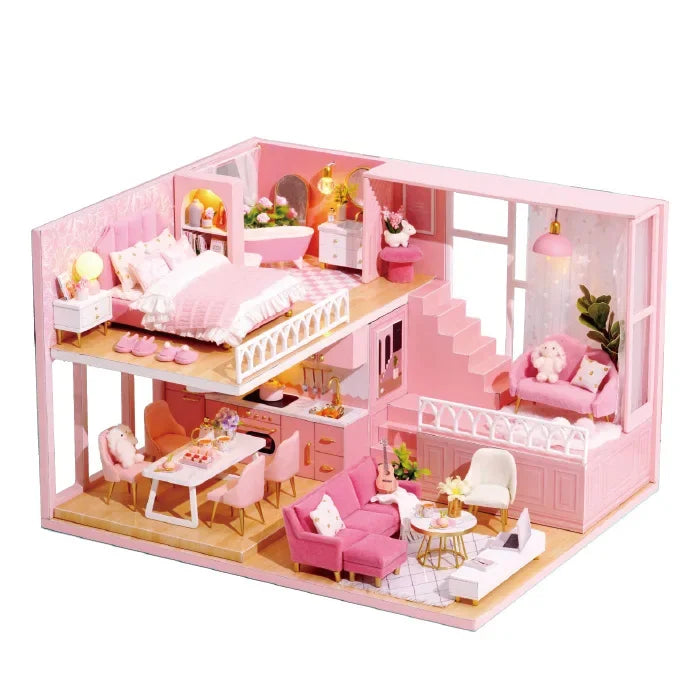 Pink dollhouse with furniture on a white background