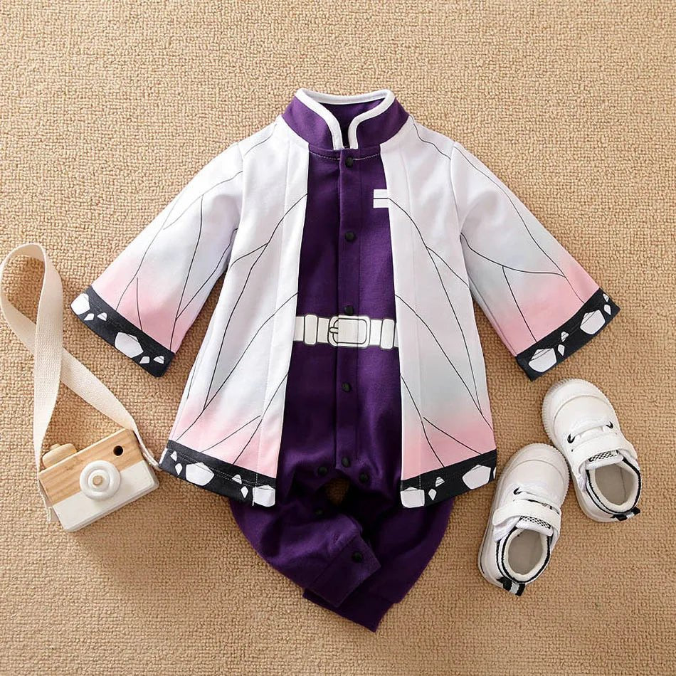 Children's outfit with purple and white design, shoes, and camera toy on a beige surface