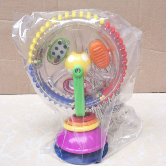 Colorful baby toy with various shapes and textures in a clear plastic bag on a beige background.