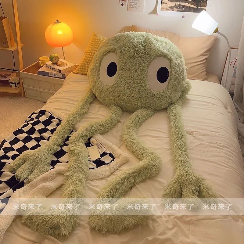 Large green plush toy on a bed in a bedroom setting