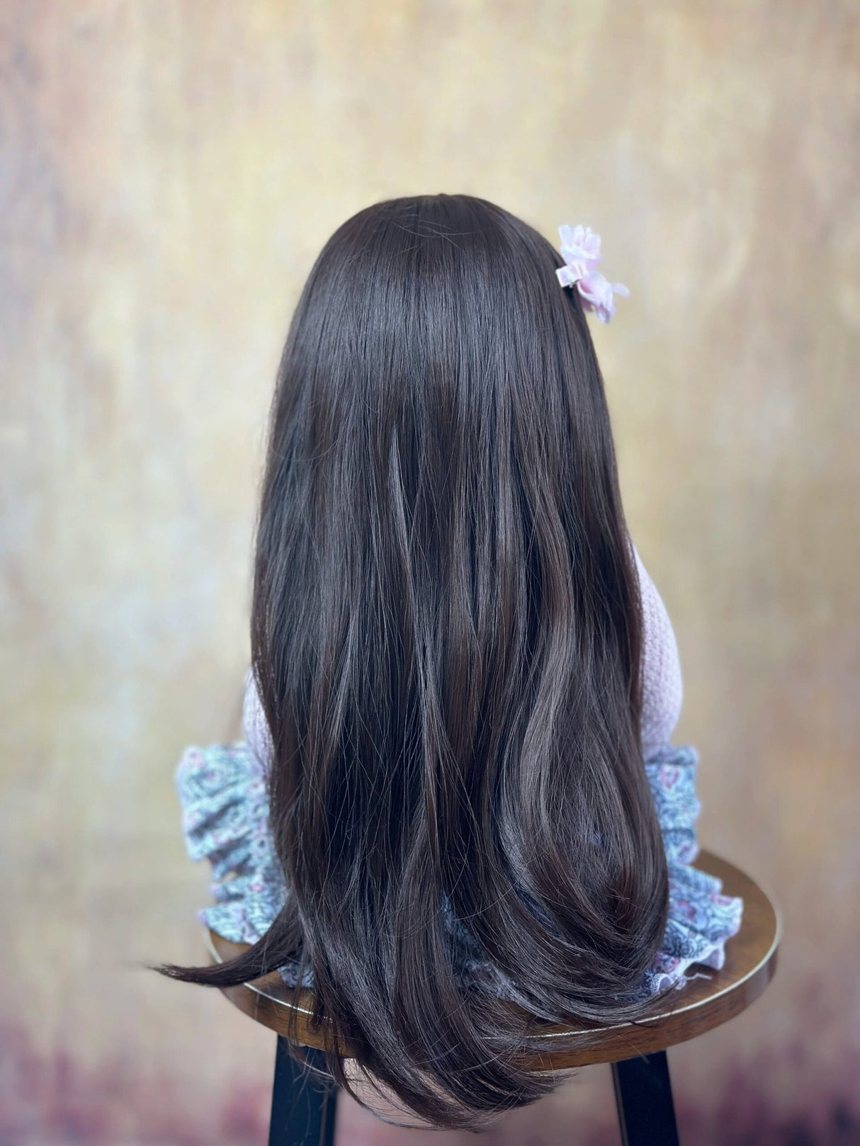 Long-haired doll with a flower hair clip