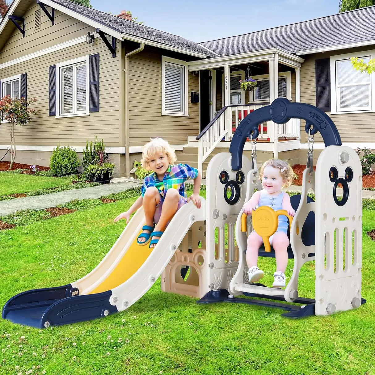 Children playing on a playground set in front of a house