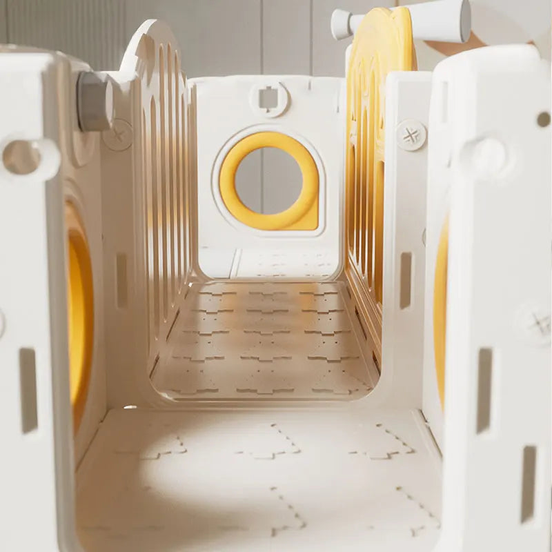 White and yellow pet playpen with multiple tunnels on a light background