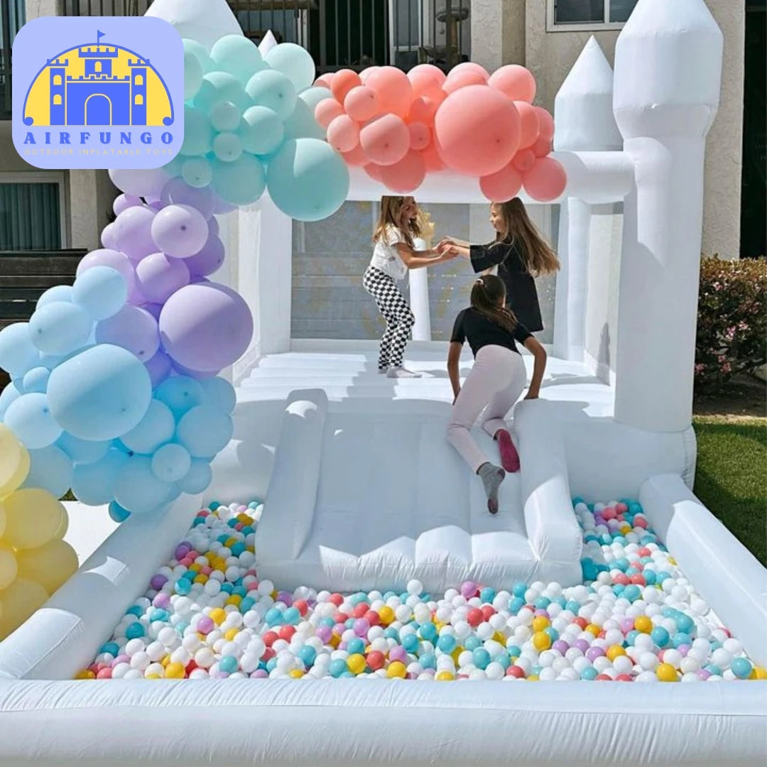 Children playing in an inflatable ball pit with colorful balloons and a castle-themed archway.