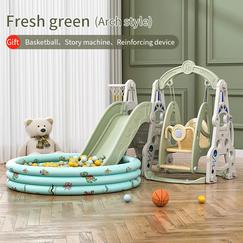 Children's play area with a green slide, swing set, and inflatable pool on a wooden floor.