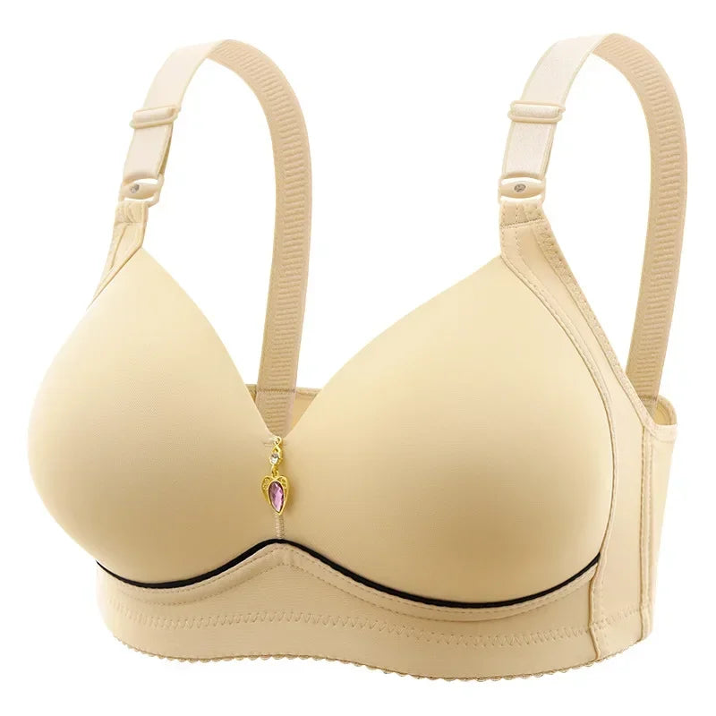 Beige bra with a decorative clasp on a white background