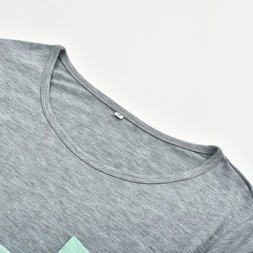 Gray t-shirt with a close-up of the neckline on a light gray background