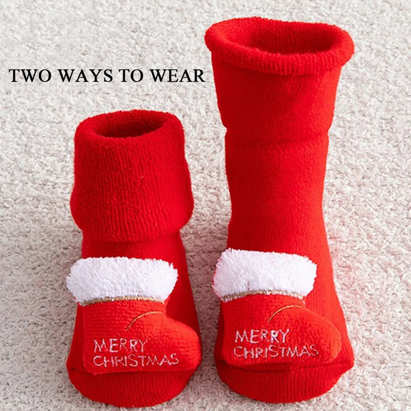 Red Christmas-themed socks with white fur trim and 'Merry Christmas' text on a textured surface.
