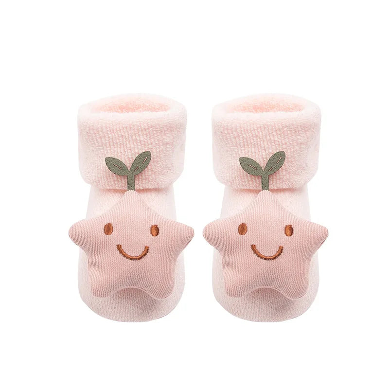 Pair of pink baby socks with star design and smiley face on a white background