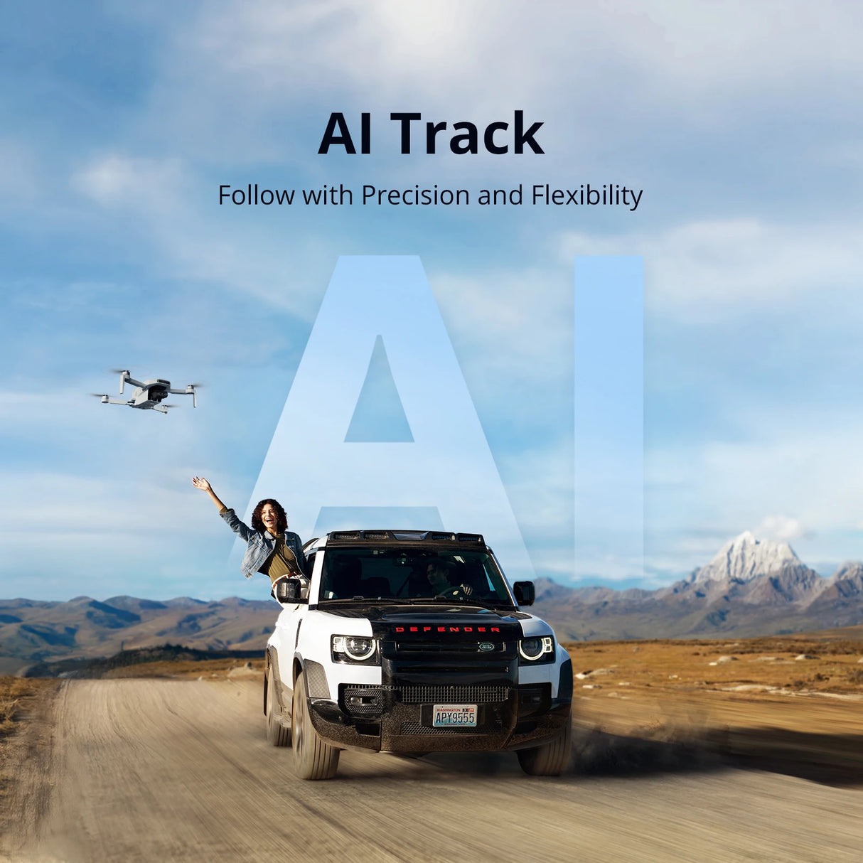 Person on a vehicle with a drone flying above, set against a mountainous landscape with 'AI Track' text.