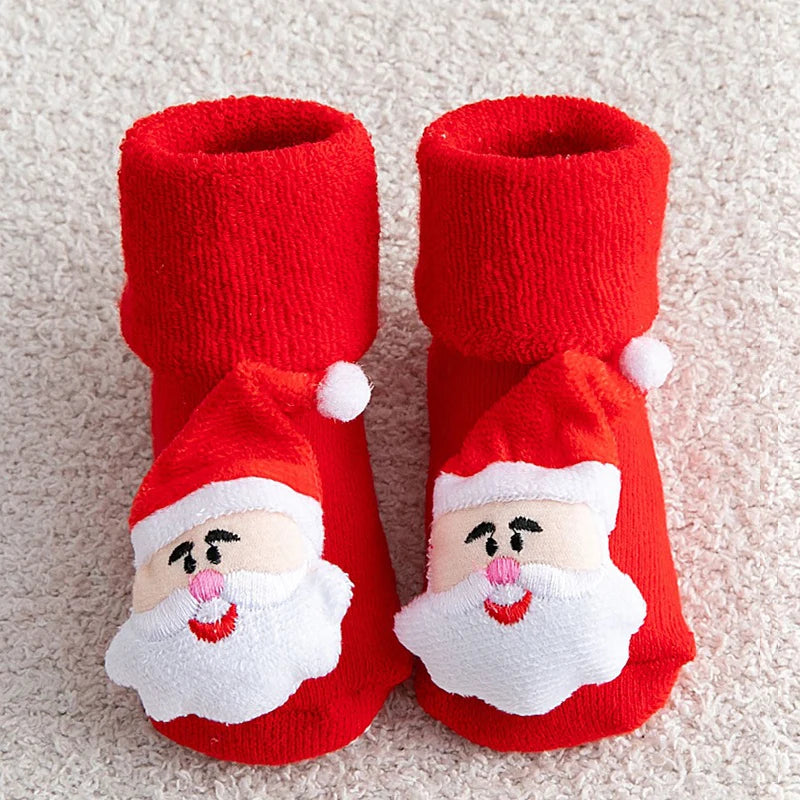 Red Santa Claus-themed baby booties on a light background