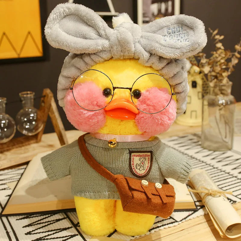 Plush toy duck with glasses and a bow tie on a decorative surface