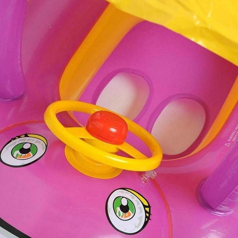 Pink inflatable toy with a yellow ring and red ball.