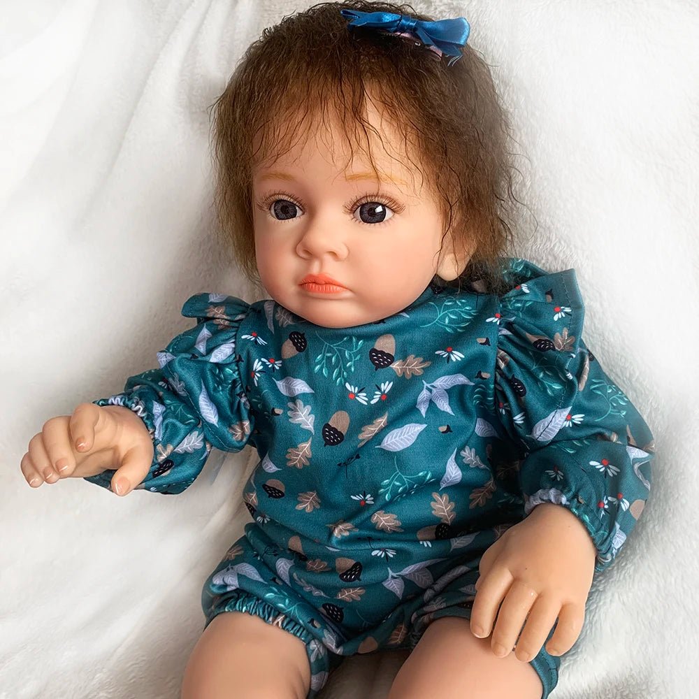 Doll wearing a teal outfit with animal prints