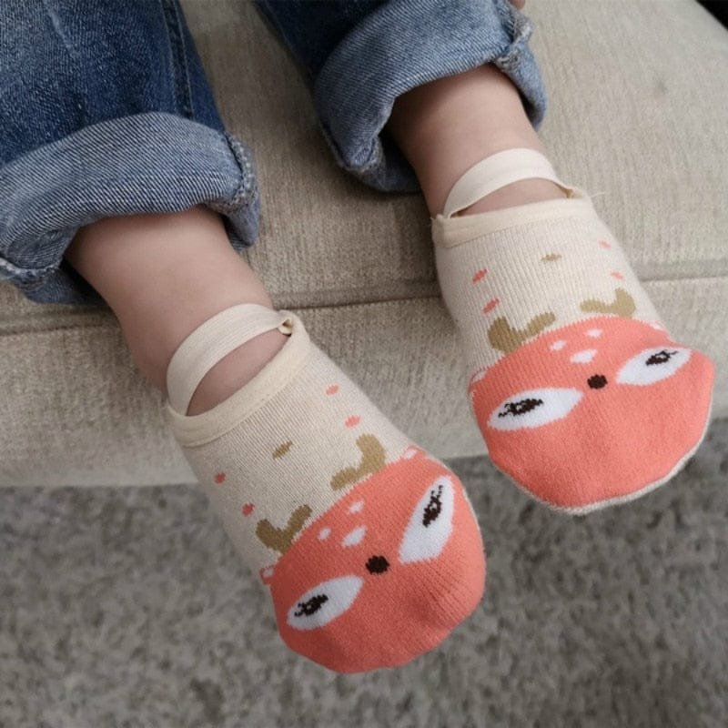 Children's socks with a fox design worn by a child in jeans.