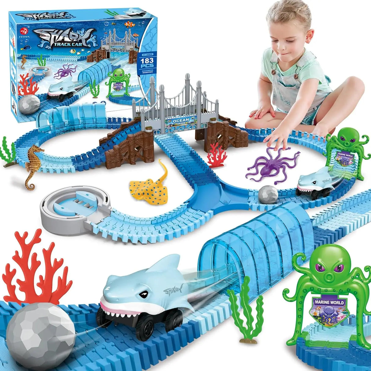 Child playing with a toy shark track set
