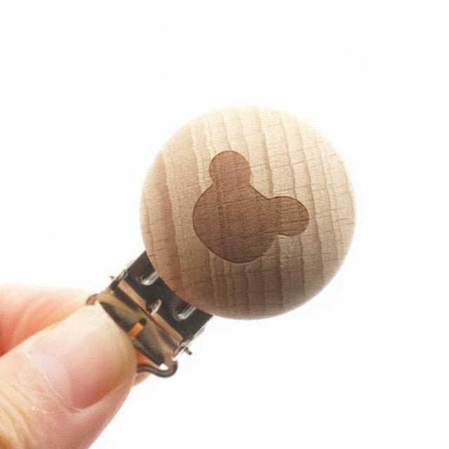Wooden pacifier clip with a bear design on a white background