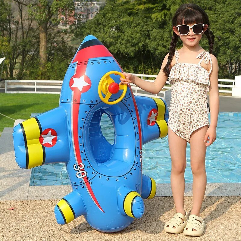 Child with an inflatable airplane pool float by a pool