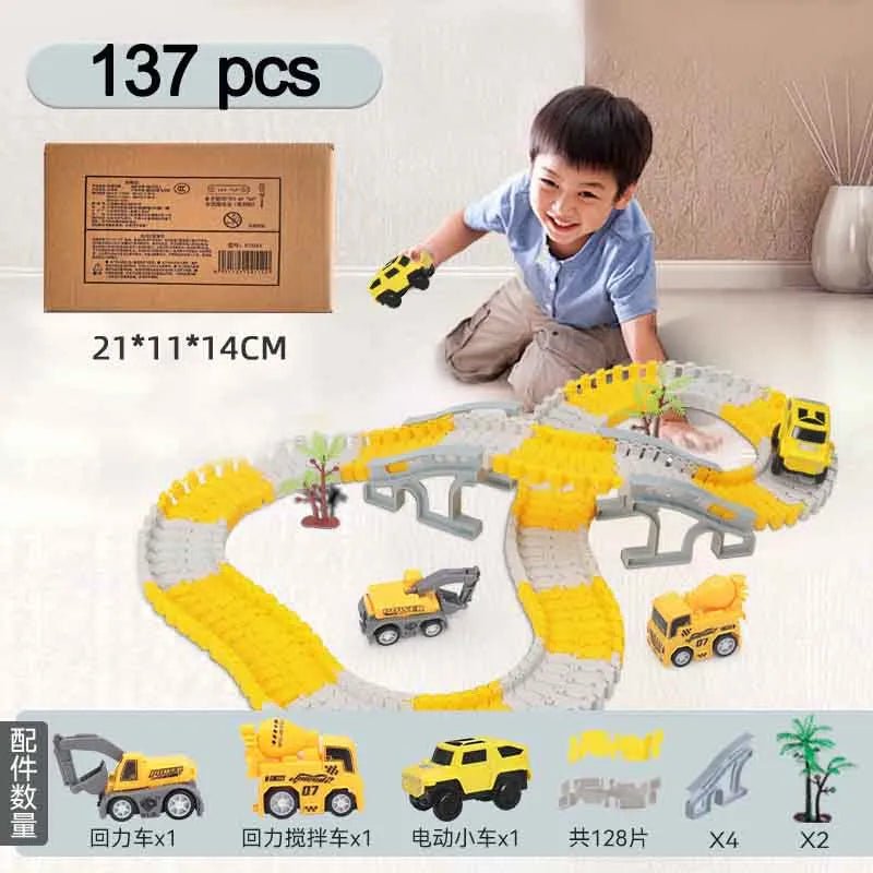 Child playing with a toy construction track set on a light-colored floor.