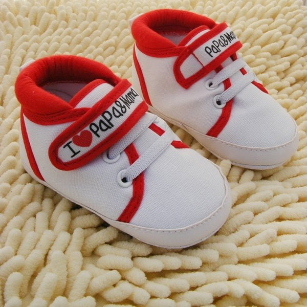 White baby shoes with red accents