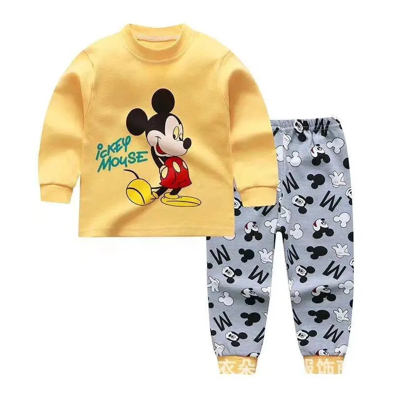 Children's pajama set with Mickey Mouse design on a yellow shirt and gray pants with patterns.