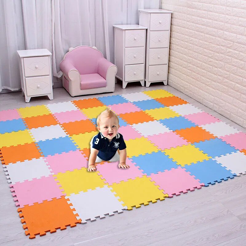 Child playing on a colorful foam puzzle mat in a room.