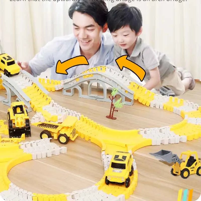 Toy construction set with tracks and vehicles on a wooden surface, featuring a man and child interacting.