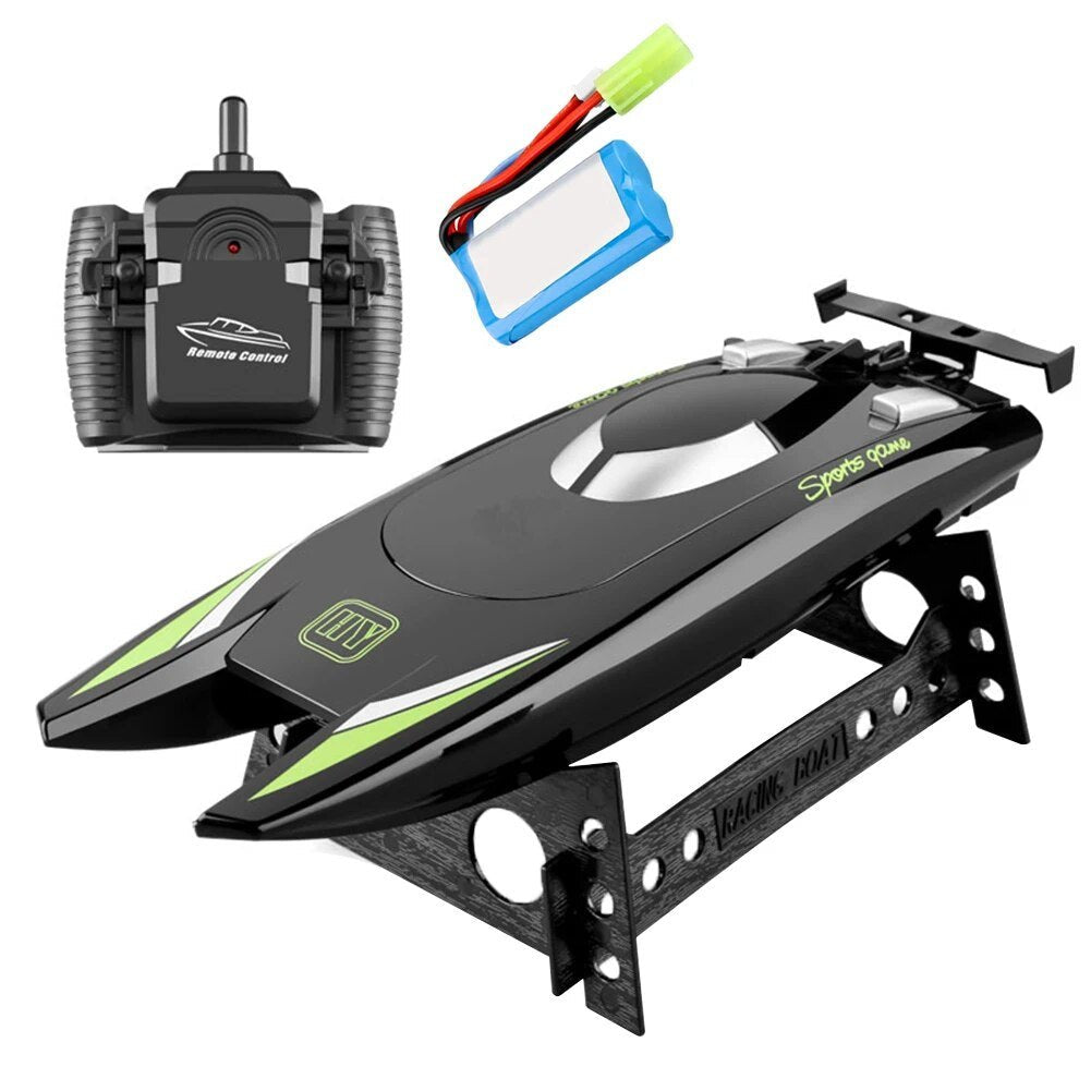 Black and green remote control boat with a transmitter and battery