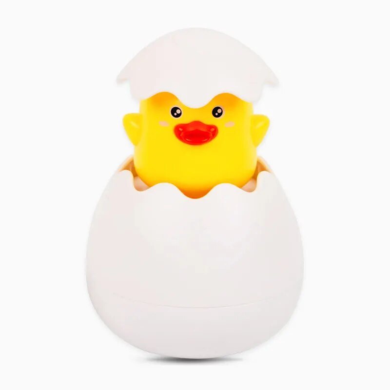Yellow rubber duck in a white egg壳 on a white background
