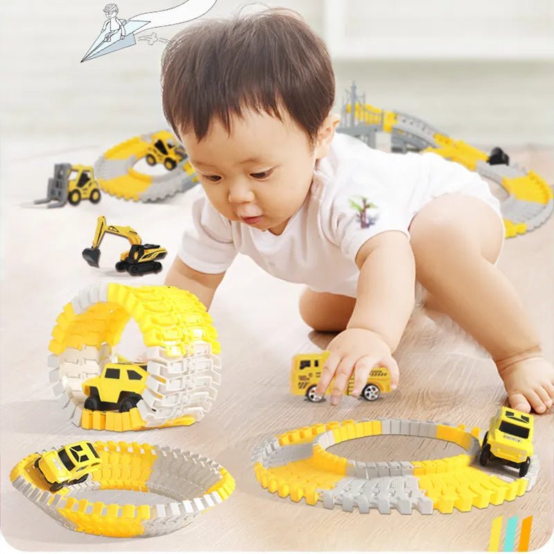 Child playing with toy construction vehicles on a track