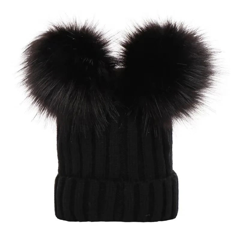 Black knit beanie with large black fur pom-poms