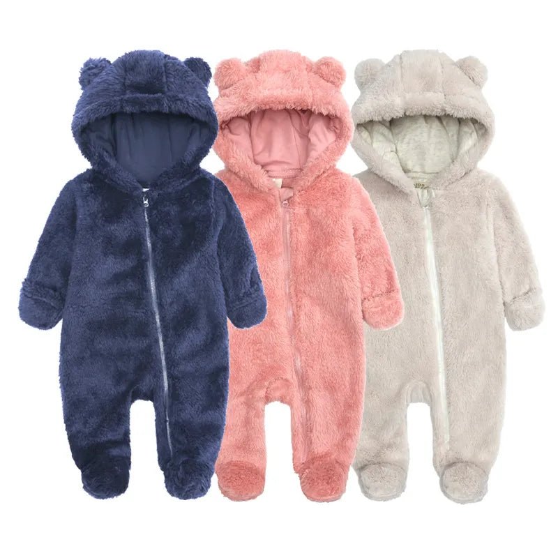Three baby onesies with bear ears in blue, pink, and gray