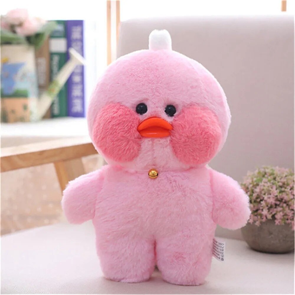 Pink plush toy with a round body and orange beak on a light background