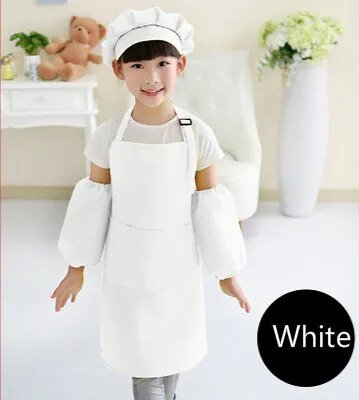 Child wearing a white chef's outfit with a hat in a room setting.