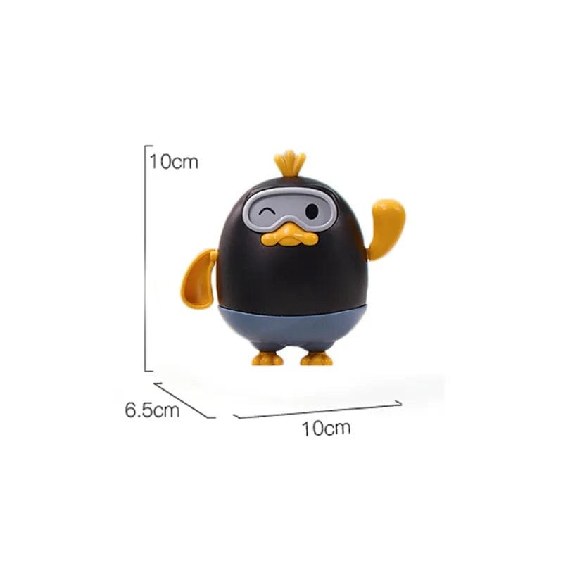 Small black and yellow penguin figurine with measurements on a white background