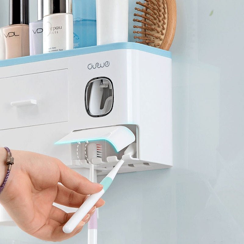Electric toothbrush being used with a wall-mounted organizer containing various toiletries.