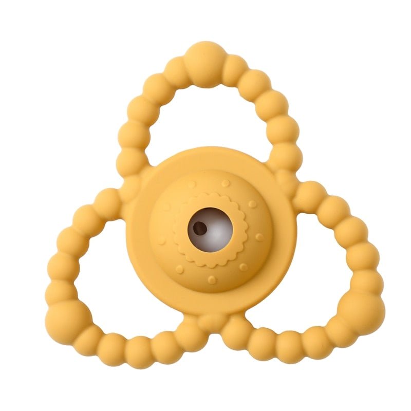 Yellow silicone teething ring on a white background