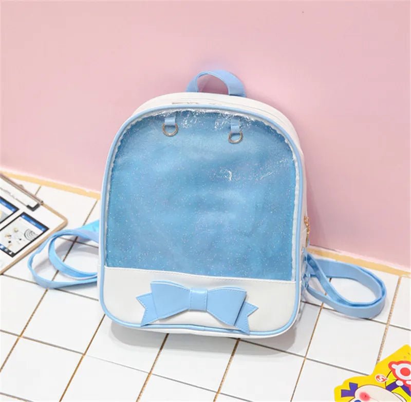 Small blue backpack with a bow on a tiled floor against a pink wall