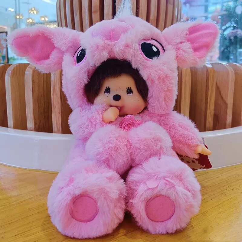 Pink plush toy with a small doll inside on a wooden surface