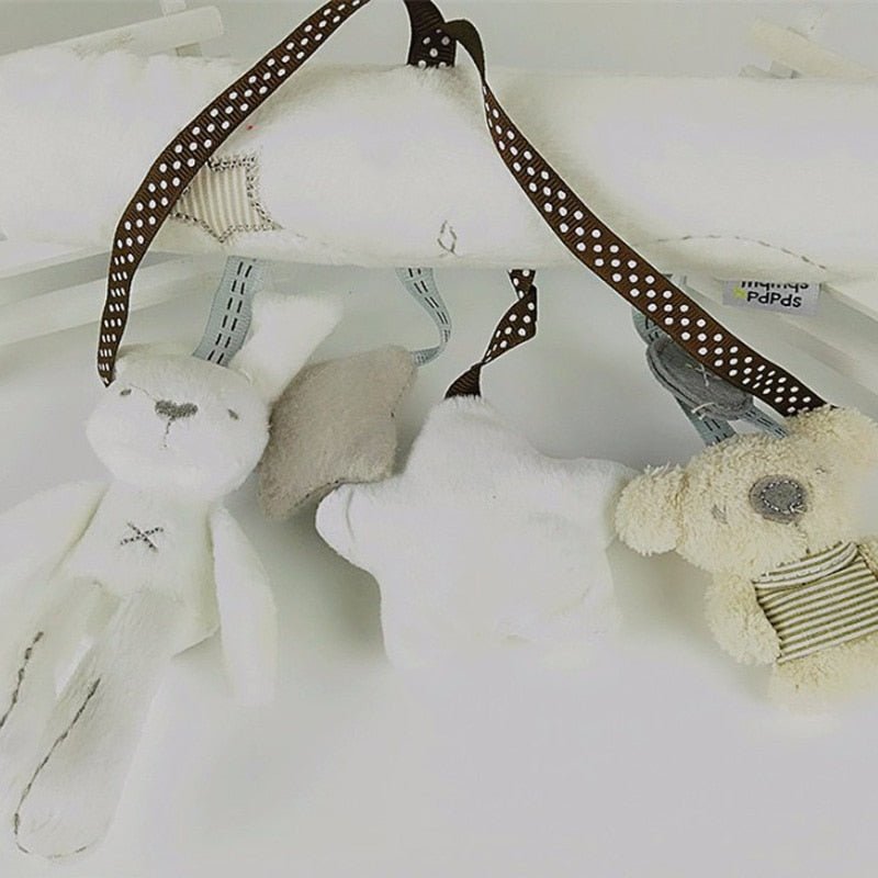 Plush toys on hangers with polka dot ribbons against a white background