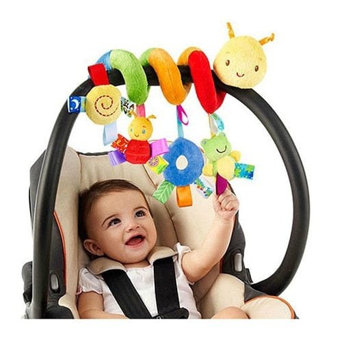 Baby in a car seat with colorful toy hanging above