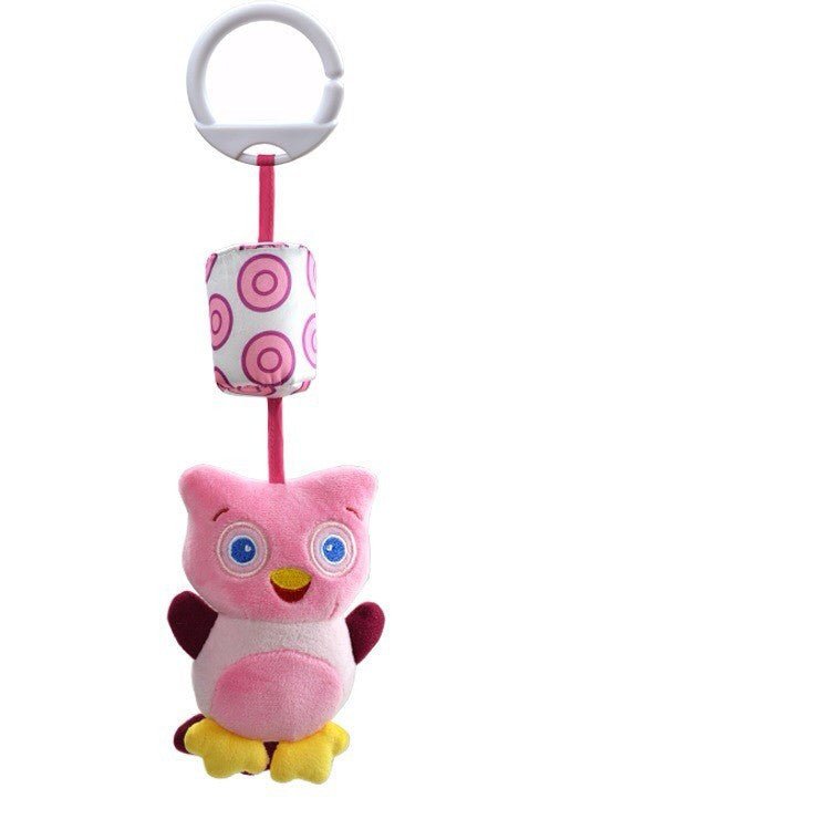 Pink owl plush toy with a hanging ring and polka dot ball on a white background