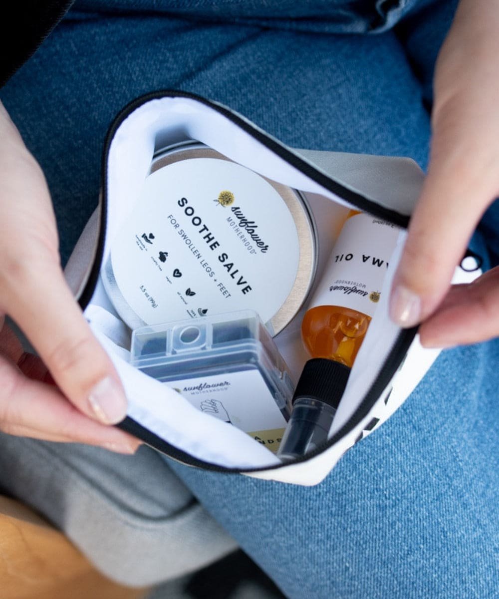 Handbag with skincare products, including a jar labeled 'Soothe Salve'