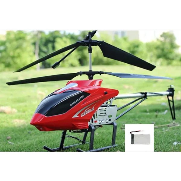 Red and black helicopter on grass with a small inset of a battery pack.