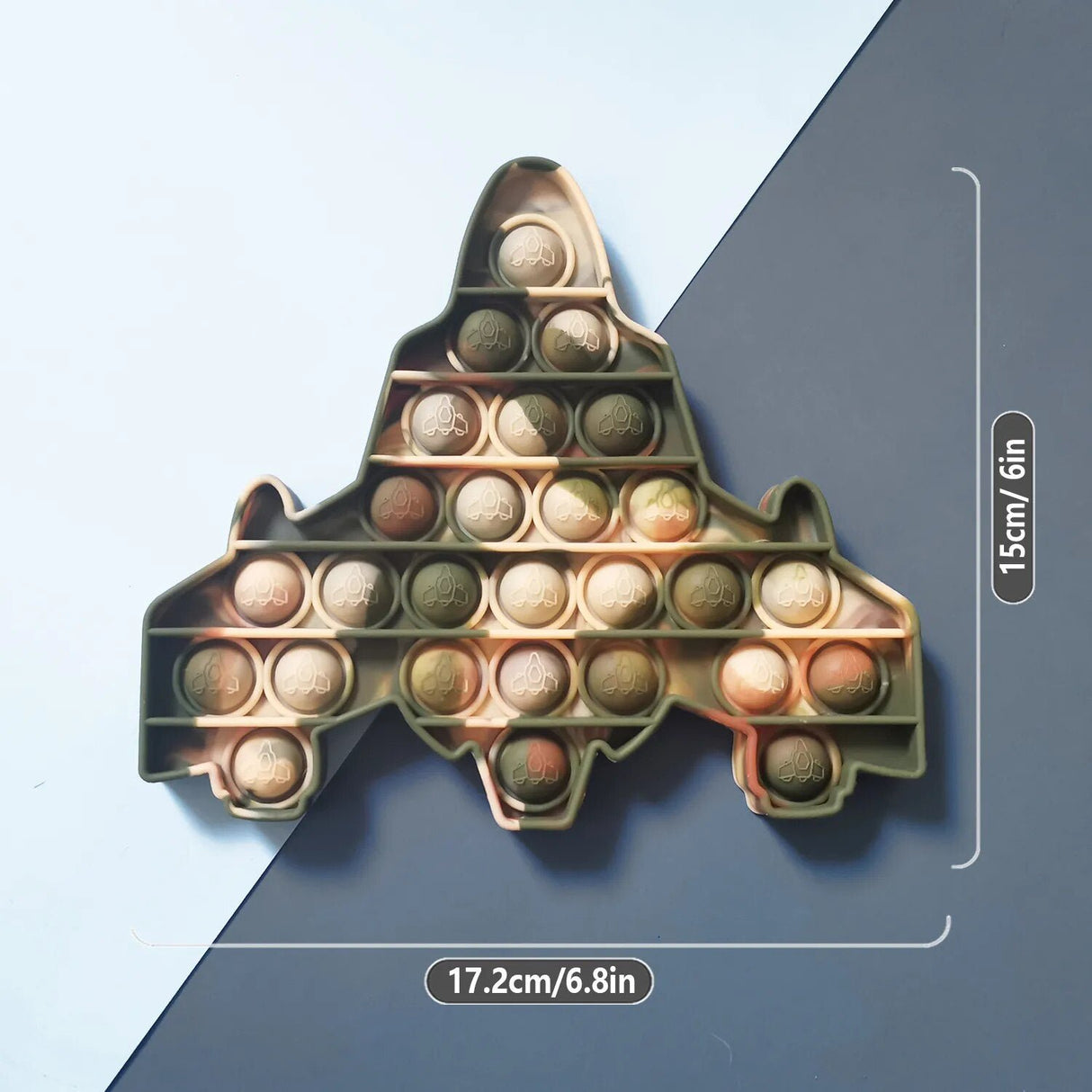 Gold airplane-shaped pop-it fidget toy with measurements on a blue and gray background