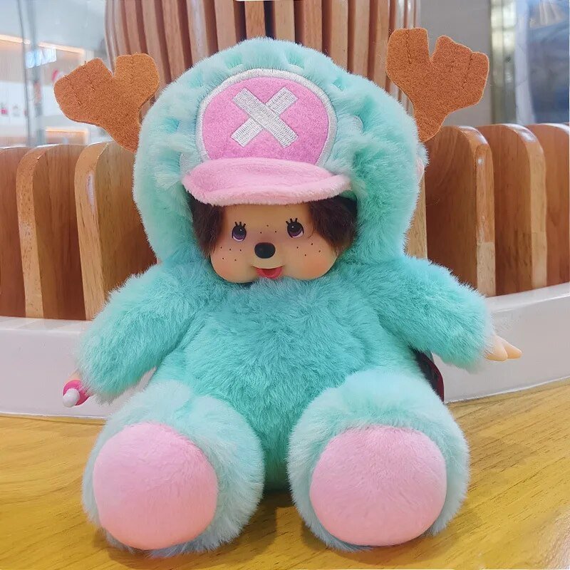 Plush toy with turquoise body, pink hat, and pink shoes on a wooden floor.