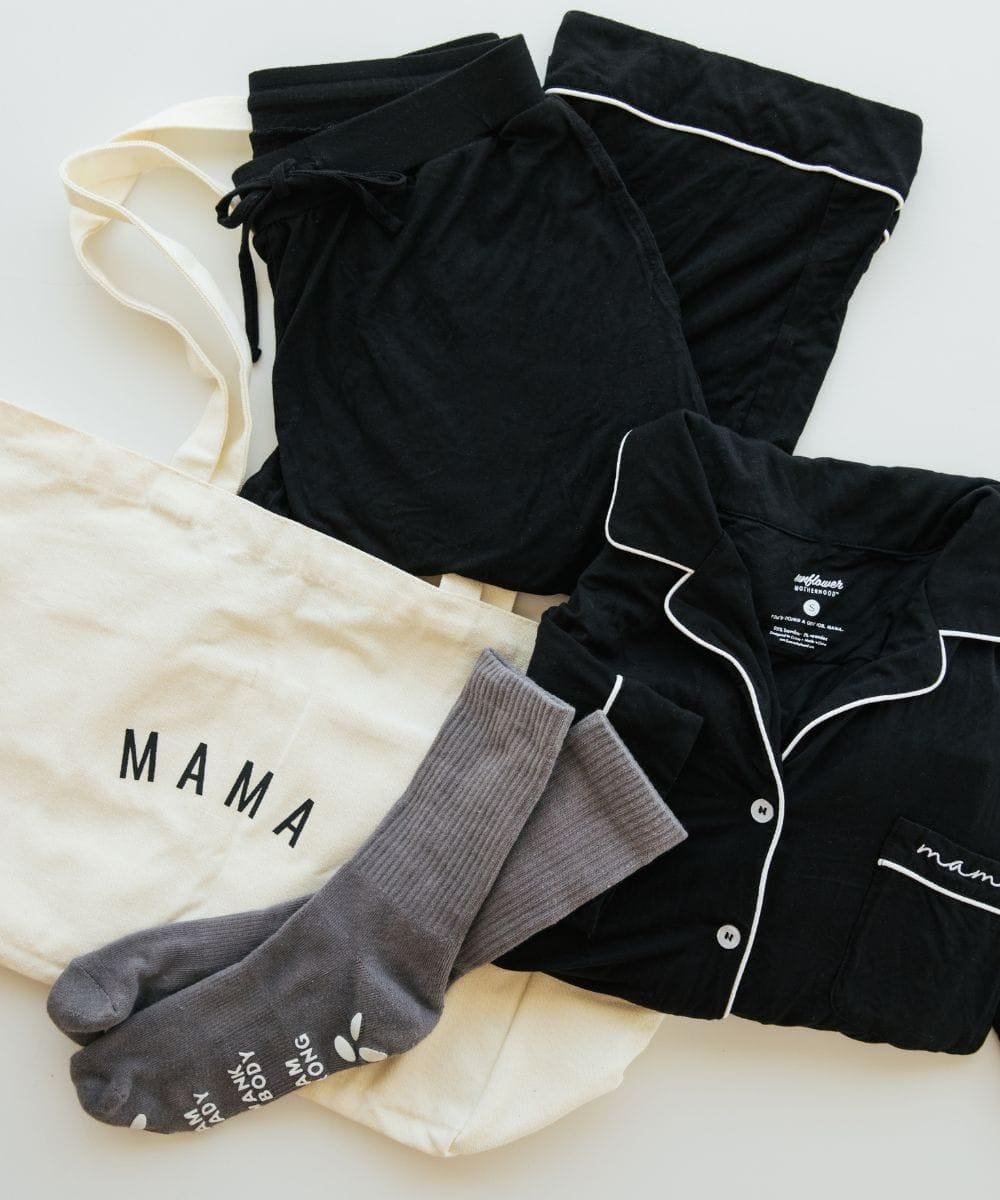Black pajama set with white piping, gray socks, and a cream shirt with 'MAMA' text.