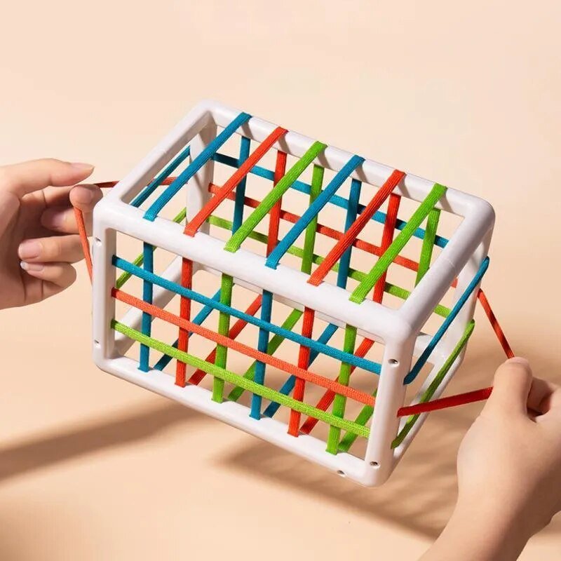 Colorful interlocking toy with sticks held by a hand.
