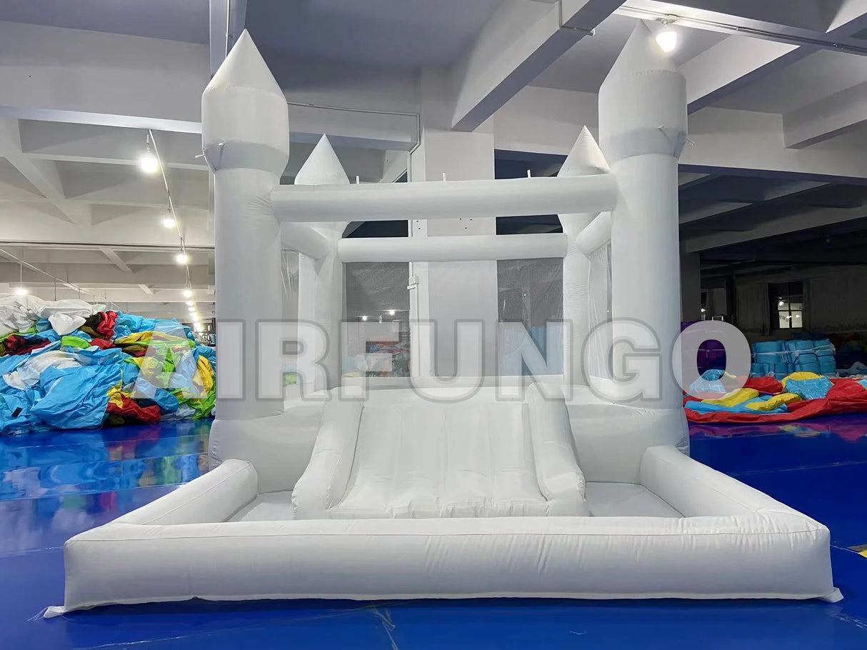 Inflatable castle with slide on a blue floor, branded 'IRENGO'.